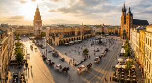 A stunning, high-angle editorial shot of Krakow’s Main Market Square at golden hour, capturing the v